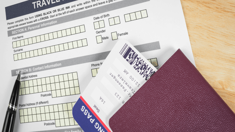 passport and boarding pass on top of an application for entry. Another one of the things to prepare before traveling abroad.