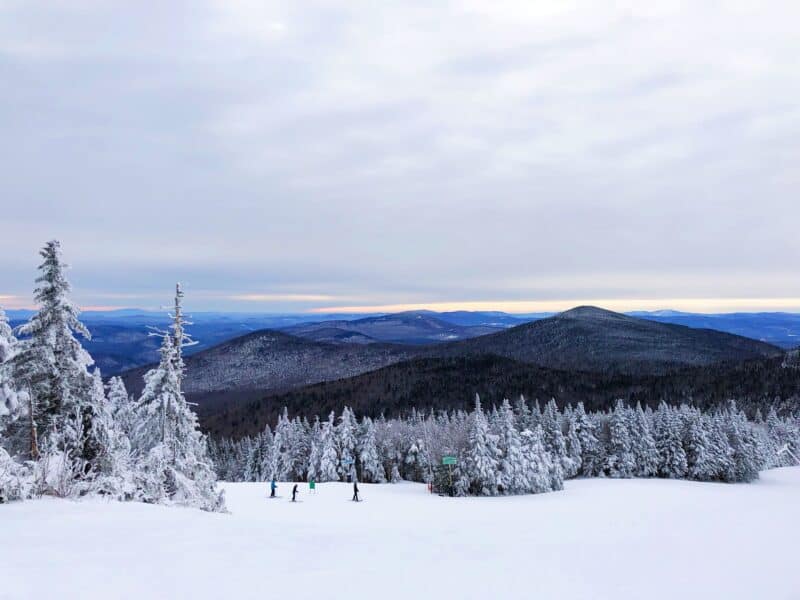 people skiing with mountains in background