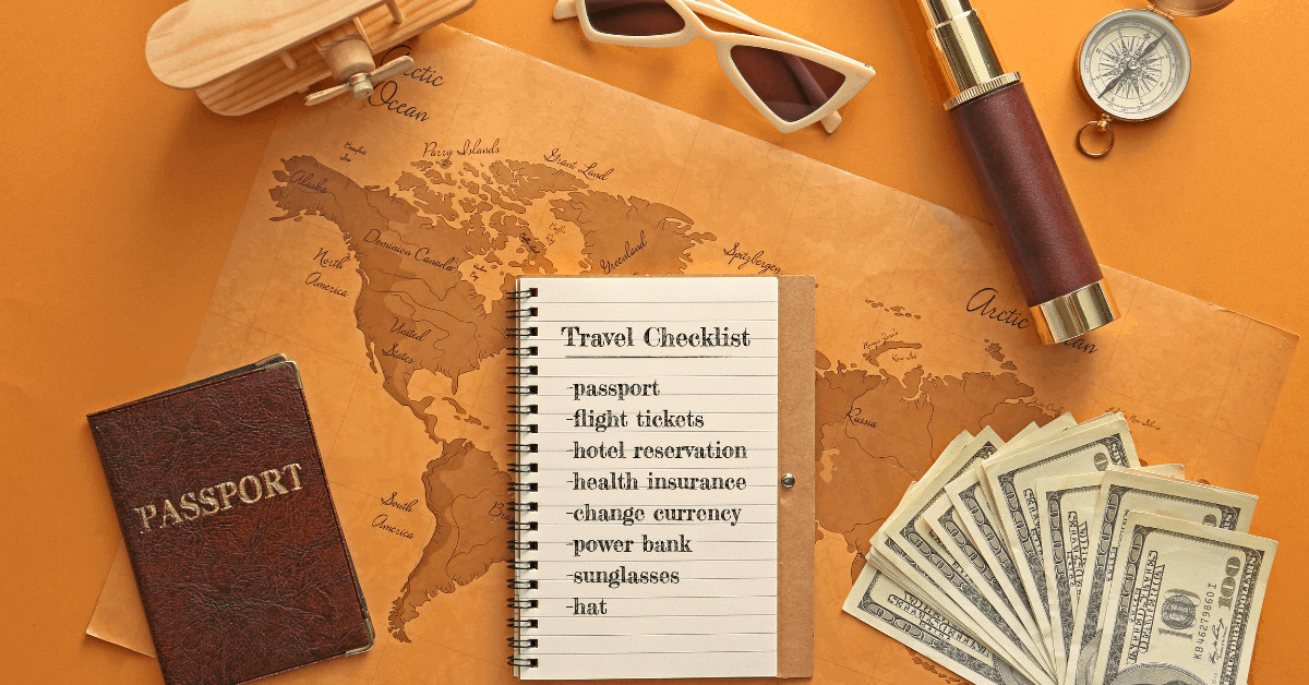 Assorted travel related items surrounding a notebook with a checklist of things to prepare before travelling abroad