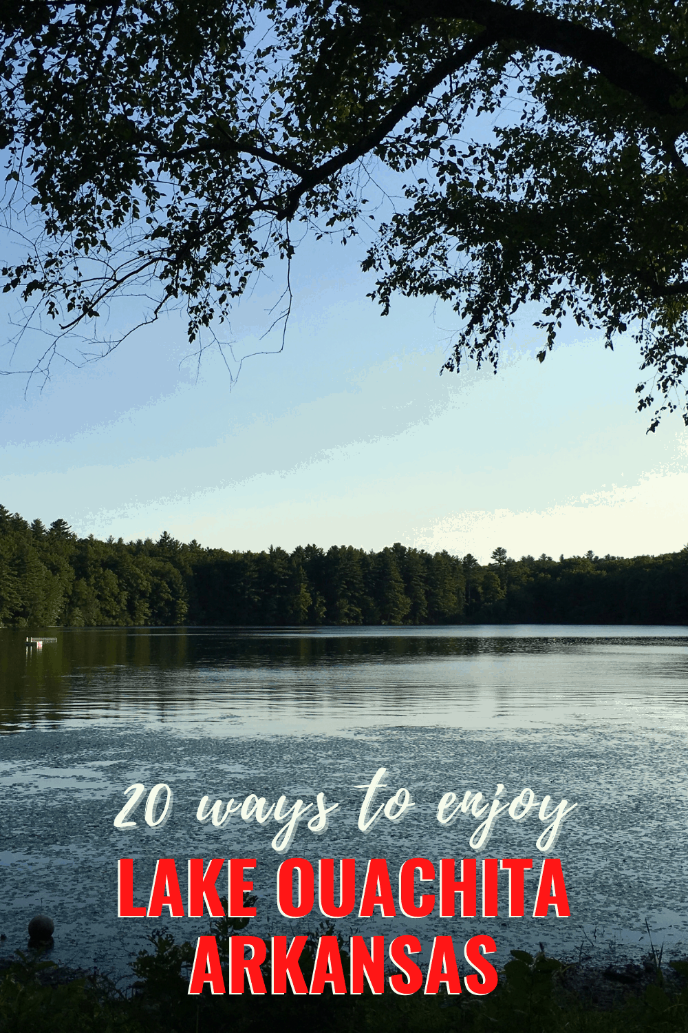 Lake framed by tree branches. Text overlay says "20 ways to enjoy Lake Ouachita Arkansas"