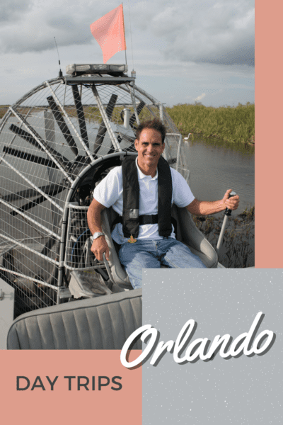 man piloting an airboat in the Florida everglades. Text overlay says "day trips Orlando"