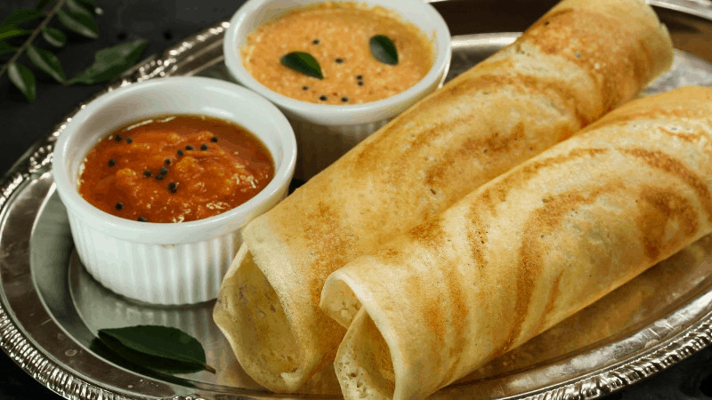 Two dosas with dal onthe side