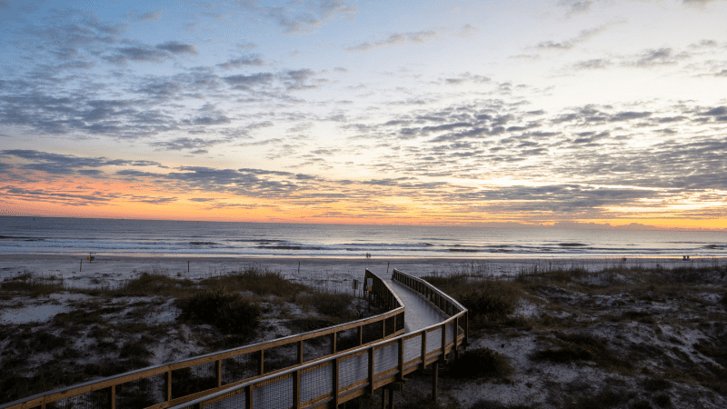 boardwalk leading down to New Smyrna Beach at sunrise
