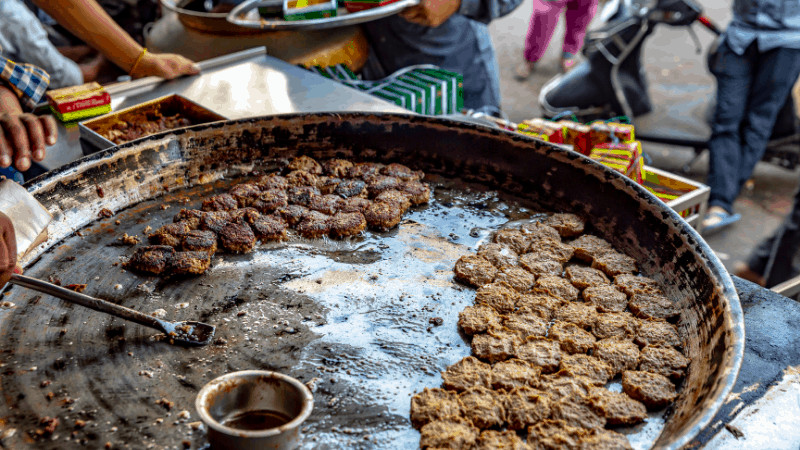 Tunday kebabs being cooked on a street food grill. Popular Indian foods.