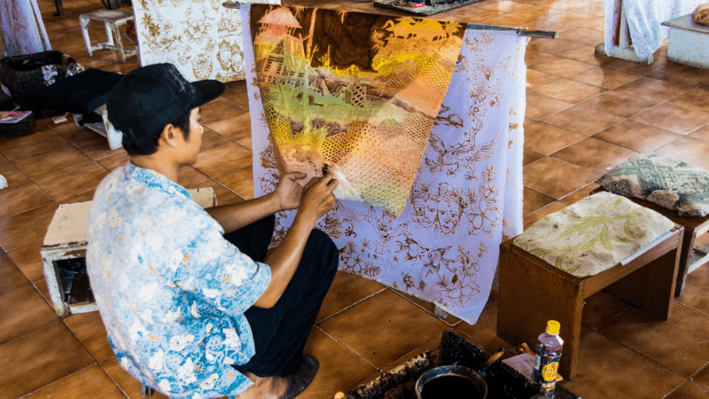 Man creating batik in Indonesia