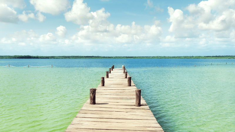 Dock leading into the blue and green waters of Laguna Ka'an Luum 