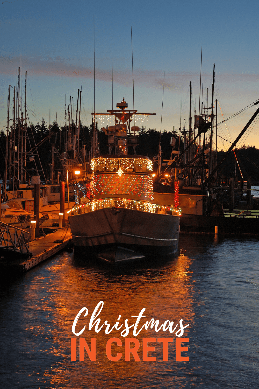 Boat in Crete decorated for Christmas. Text overlay says Christmas in Crete