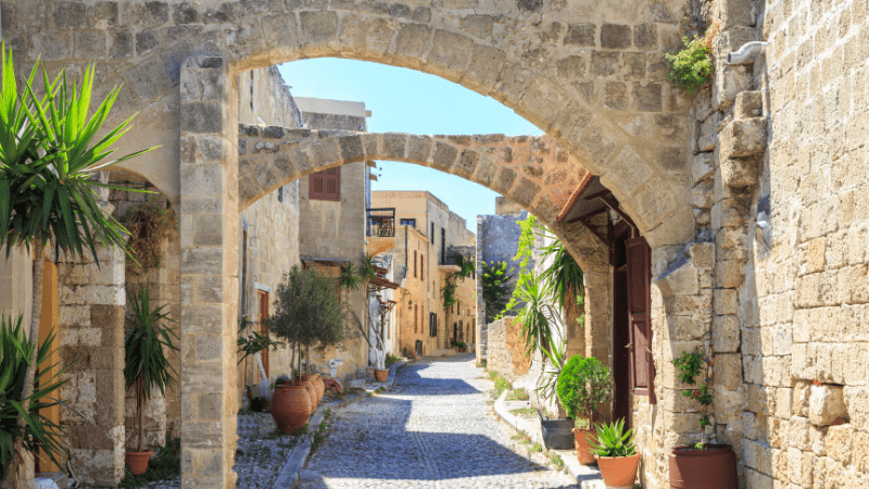Ancient road framed by arches overhead in Rhodes Greece