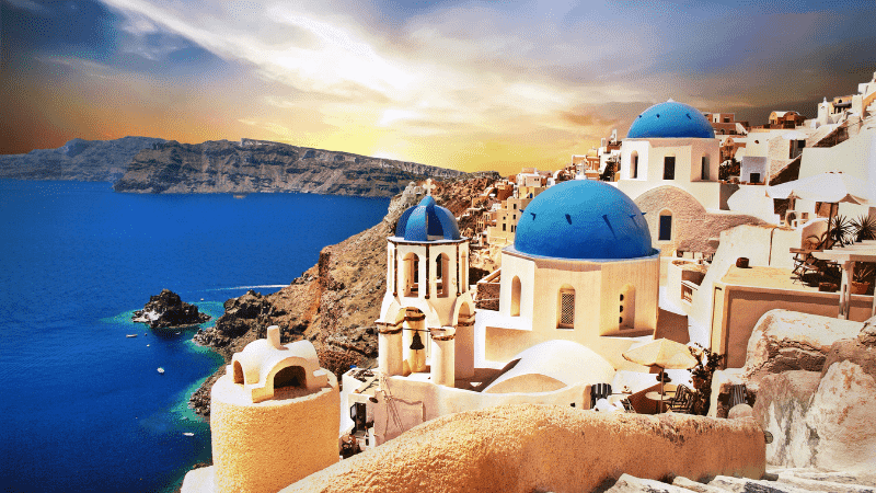 Wondering which Greek island should I visit? Check out the blue domes and houses in Santorini, with the deep blue Mediterranean as a backdrop.