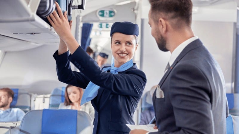 Flight attendant smiling at passenger