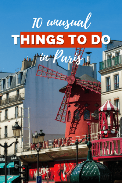 Windmill of Moulin Rouge between two buildings in Paris. Text overlay says "10 unusual things to Do in Paris"