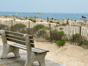 empty pak bench overlooking Atlantic Ocean and one of the Jersey Shore beaches