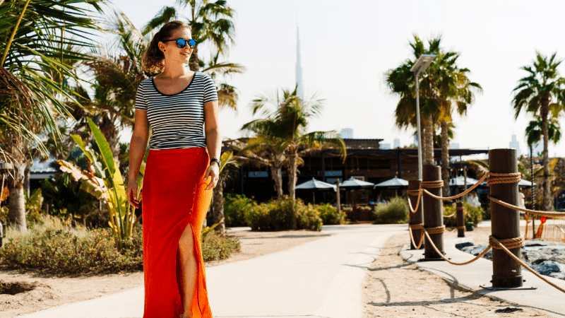 Woman on a walkway with Burj Khalifa in the background