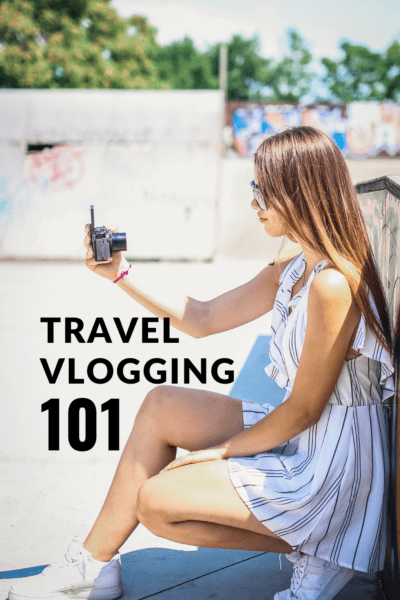 Woman taking a video of herself with camera. Text overlay says "travel vlogging 101"