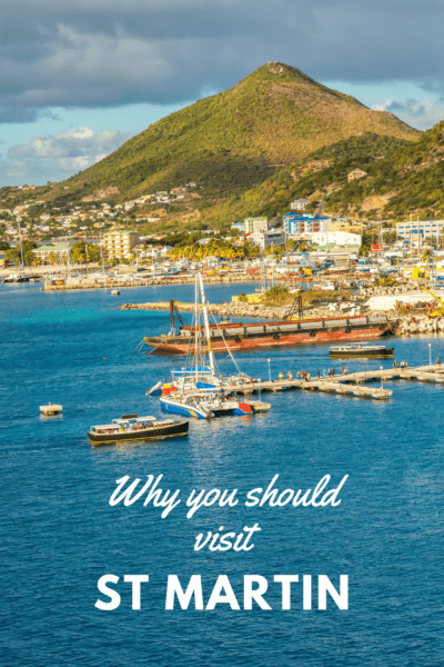 boats at anchor with hill in background. Text overlay says why you should visit st martin