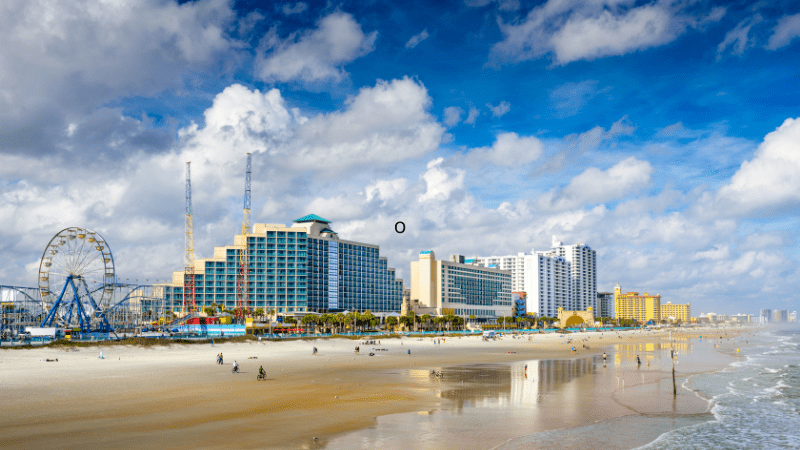 boardwalk in Daytona Beach with amusement park behind the buildings