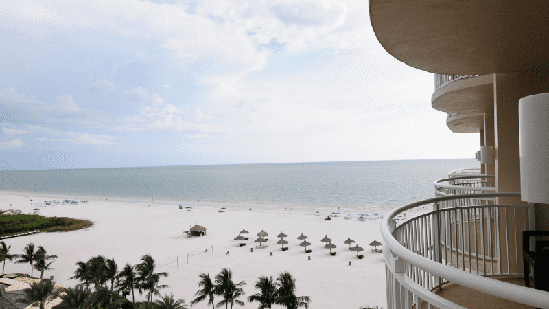 beach, chairs, and ocean, as seen from Marco Island balcony