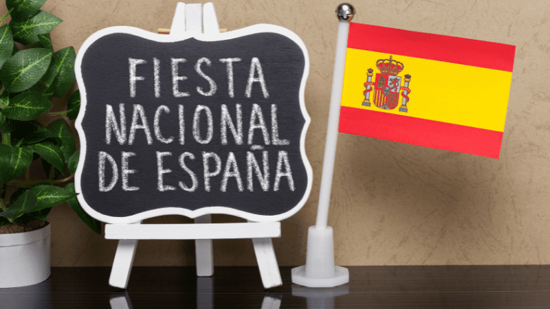 Spanish flag and sign saying Fiesta Nacional de Espana, which means Spain National Day