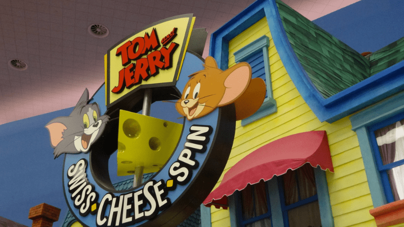 Closeup of ride at Warner Bros Abu Dhabi. Sign says Tom & Jerry Swiss Cheese Spin. Images of Tom and Jerry cartoon characters
