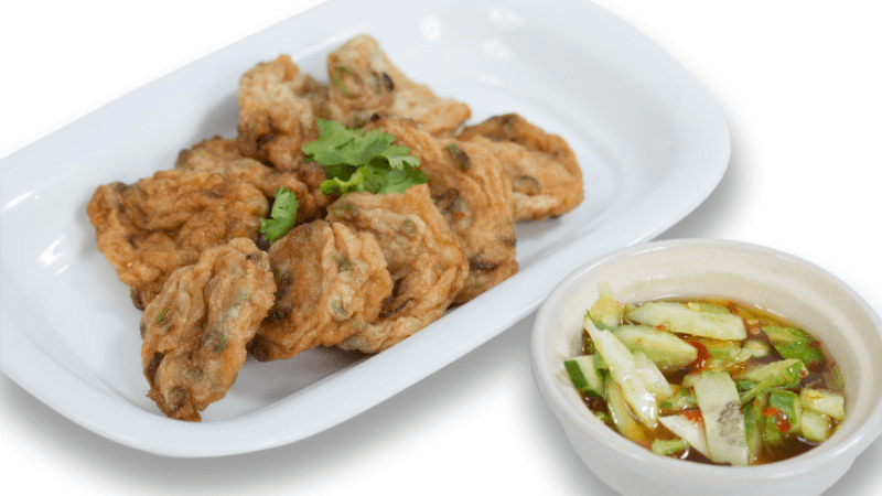 platter with fish cakes and a small bowl of dipping sauce