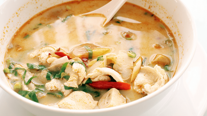 closeup of a bowl of tom yum soup