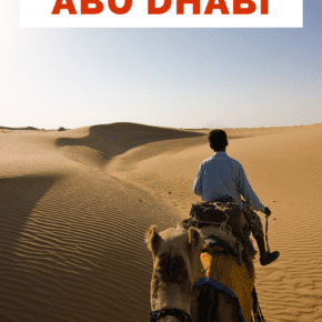 Man on camel in desert safari. Text overlay says "top things to do in Abu Dhabi"