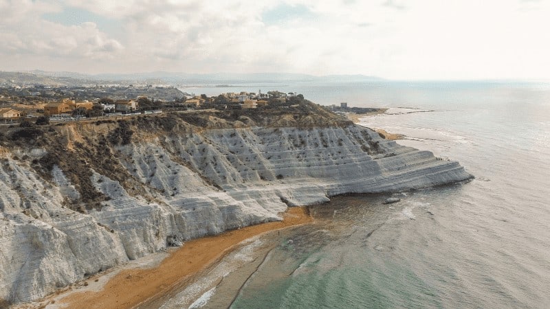 The white cliff of Scala dei Turchi near Agrigento, with beach in foreground