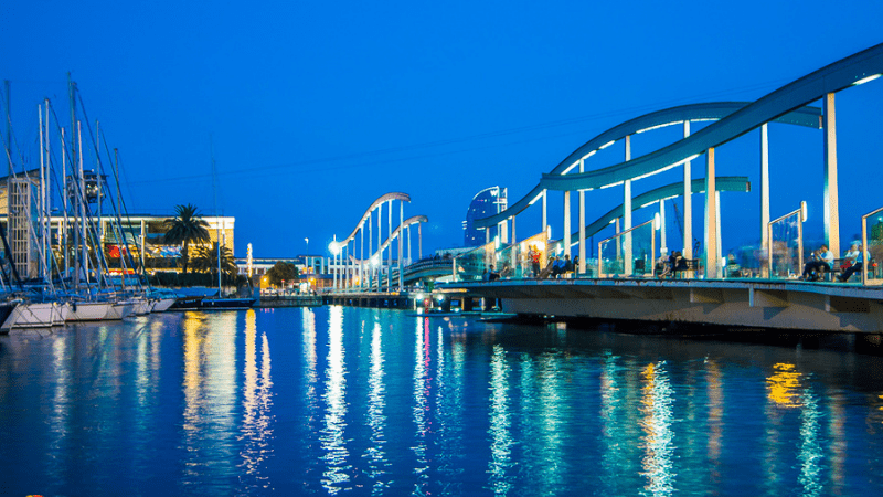 Barcelona pier and water illuminated at nighttime. Good spot for student travel