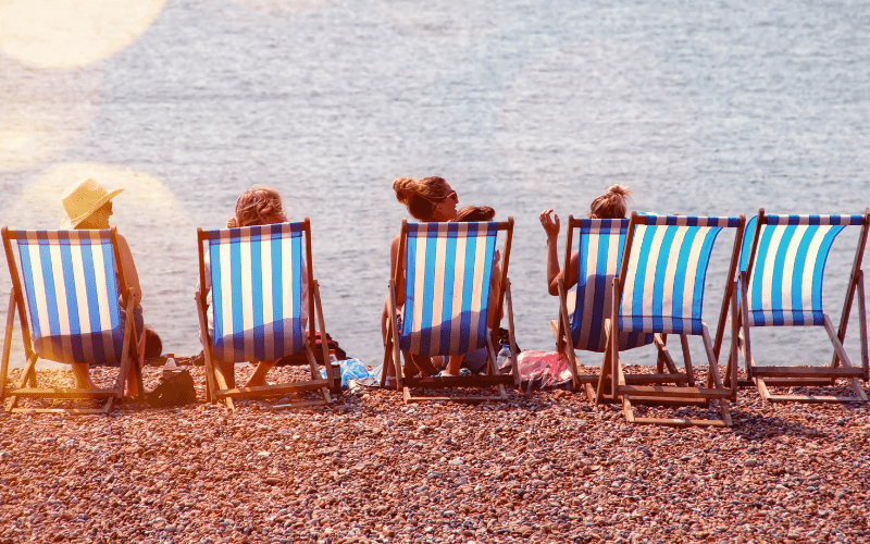 four people in beach chairs