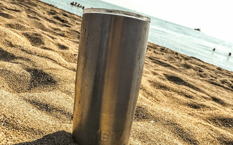 Yeti insulated mug on a beach