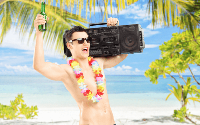 guy waving a beer bottle with a boombox on his shoulder