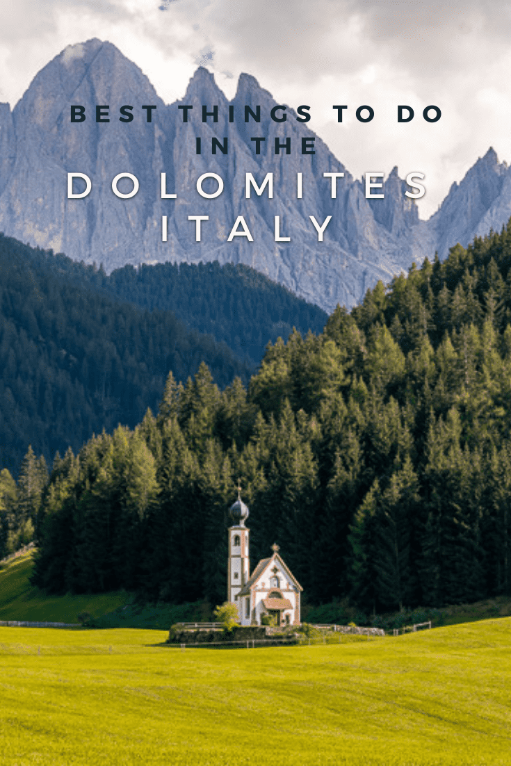 Church of St. John in Ranui. with mountains and a pine forest in the background. Text overlay says "best things to do in the Dolomites Italy"