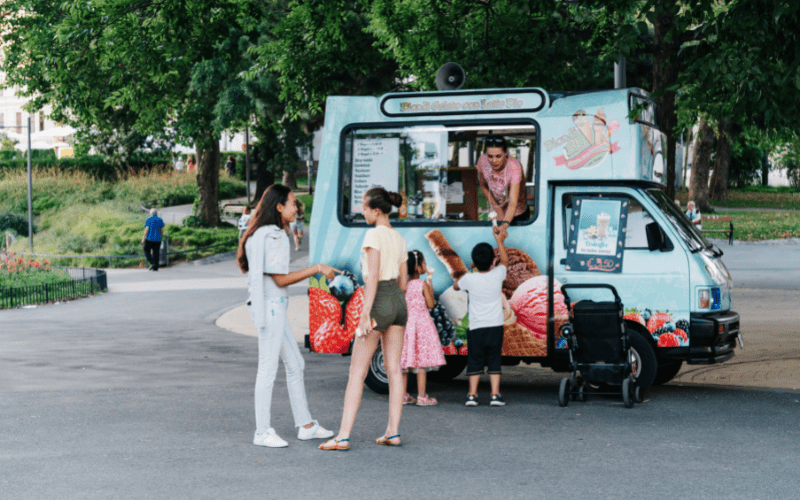 children buying treats at an ice cream truck