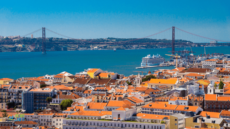 Terra cotta roofs in Lisbon Portugal, with water in background
