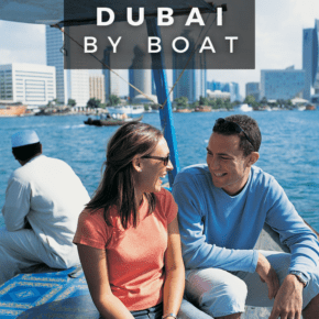 Couple sitting on a boat and looking at each other. Text overlay says "things to do dubai by boat"
