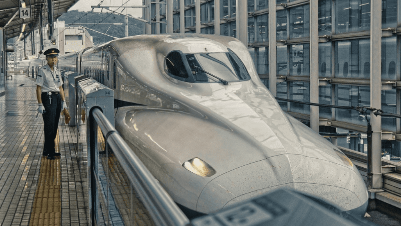 Tokyo to Kyoto Shinkansen Bullet Train, with man standing beside it.