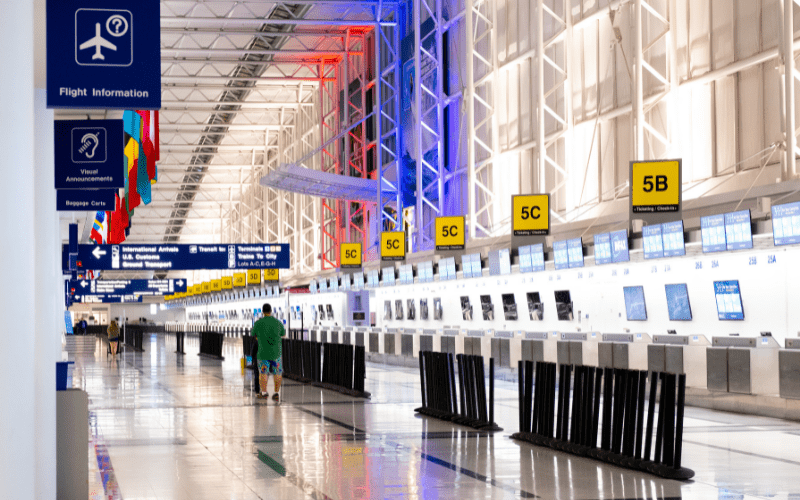 a line of airport terminal check-in counter desks