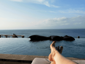 best time to visit java indonesia luxury experiences in Bali - feet on a lounge chair with pool in background