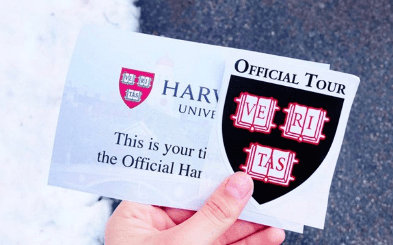 Hand holding a Harvard tour ticket
