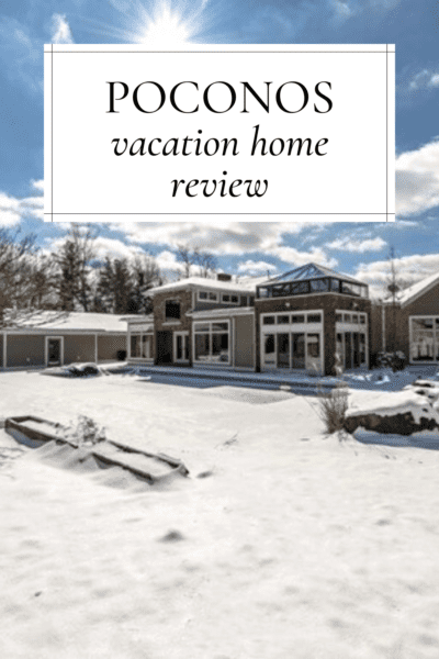 Exterior of the vacation home rental surrounded by snow. Text overlay says "Poconos Vacation Home Review"