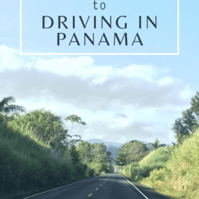 view down a panama road with mountains in the background. Text overlay says "road trip guide to driving in Panama"