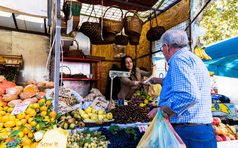 man buying food at a local market in Split Croatia