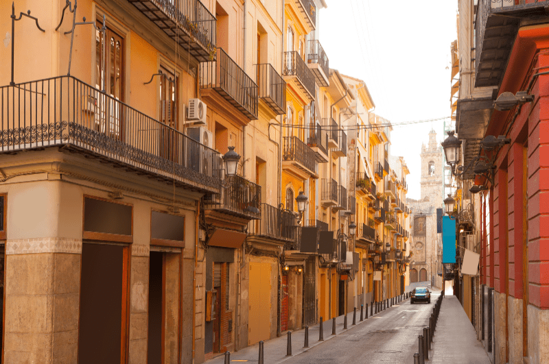 street in Valencia. The text overlay says "best places to live in Spain"