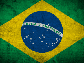 The national flag of Brazil, a blue disc depicting a starry sky (which includes the Southern Cross) spanned by a curved band inscribed with the national motto "Ordem e Progresso" ("Order and Progress"), within a yellow rhombus, on a green field.