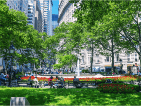 People in a park in the middle of New York City in summer time