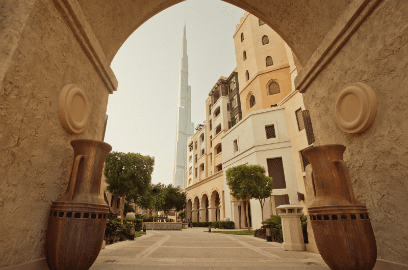 Burj Khalifa and houses framed by an archway in Dubai