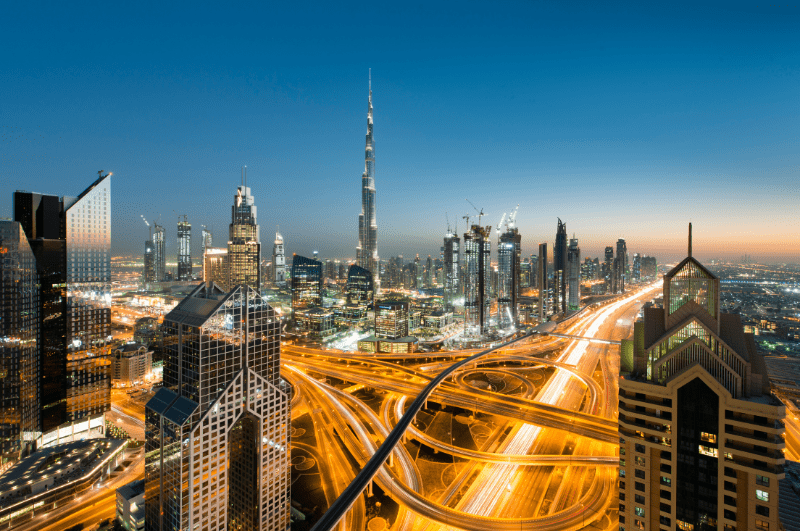 Highways illuminated by car lights in a time-lapse photo of Dubai city.