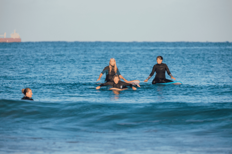 people taking a surf lesson