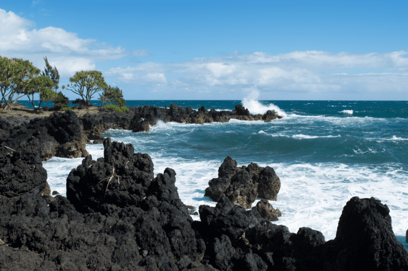 black rocks seen along the coast on the Road to Hana