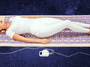 Woman lying on a PEMF mat